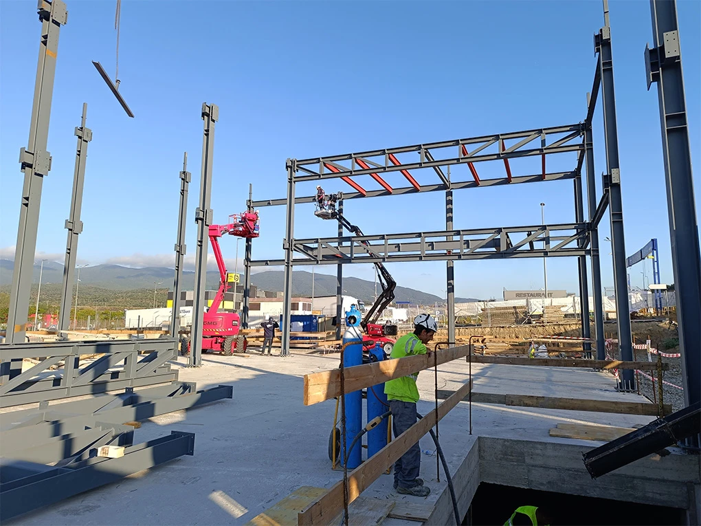Construcción de nave industrial con estructura metálica y trabajos de obra