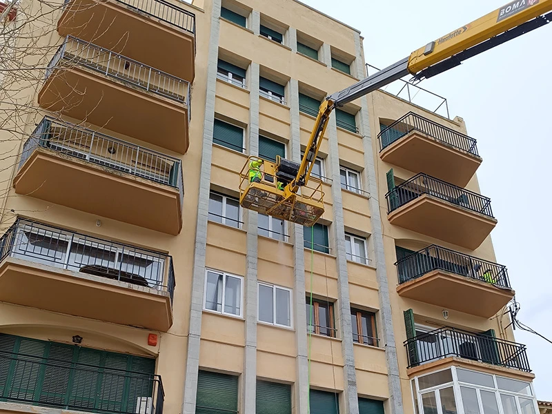 Trabajos de mantenimiento de edificios en fachada y zonas comunes con plataforma elevadora